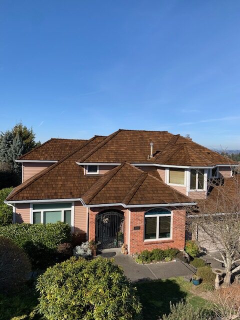 Brick home with copper gutter installation and visible fascia board in Pierce County