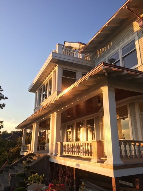 Home with copper gutter system catching golden hour sunlight