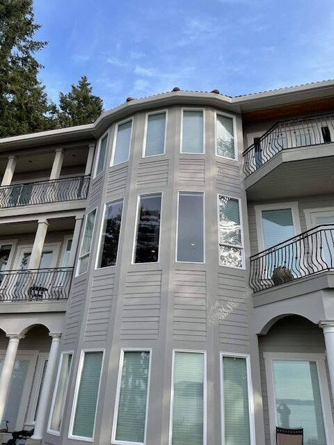 Multi-story white home with seamless gutter installation